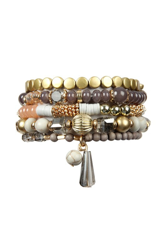 This is a photo of ta Multi Beads Stretch bracelet in gray which features metal, acrylic and natural stone beads in gray, gold and white.  