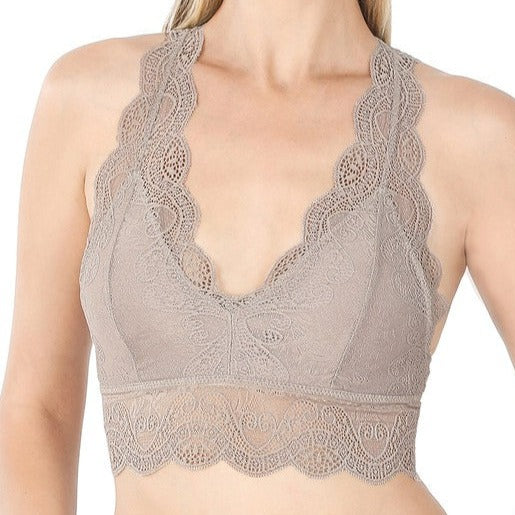 This is a photo of a model wearing a Strech Lace Bralette in ash mocha.  The bra has a traditional spaghetti strap, v shaped neckline and features extra wide lace camisole straps and bottom lace band.  